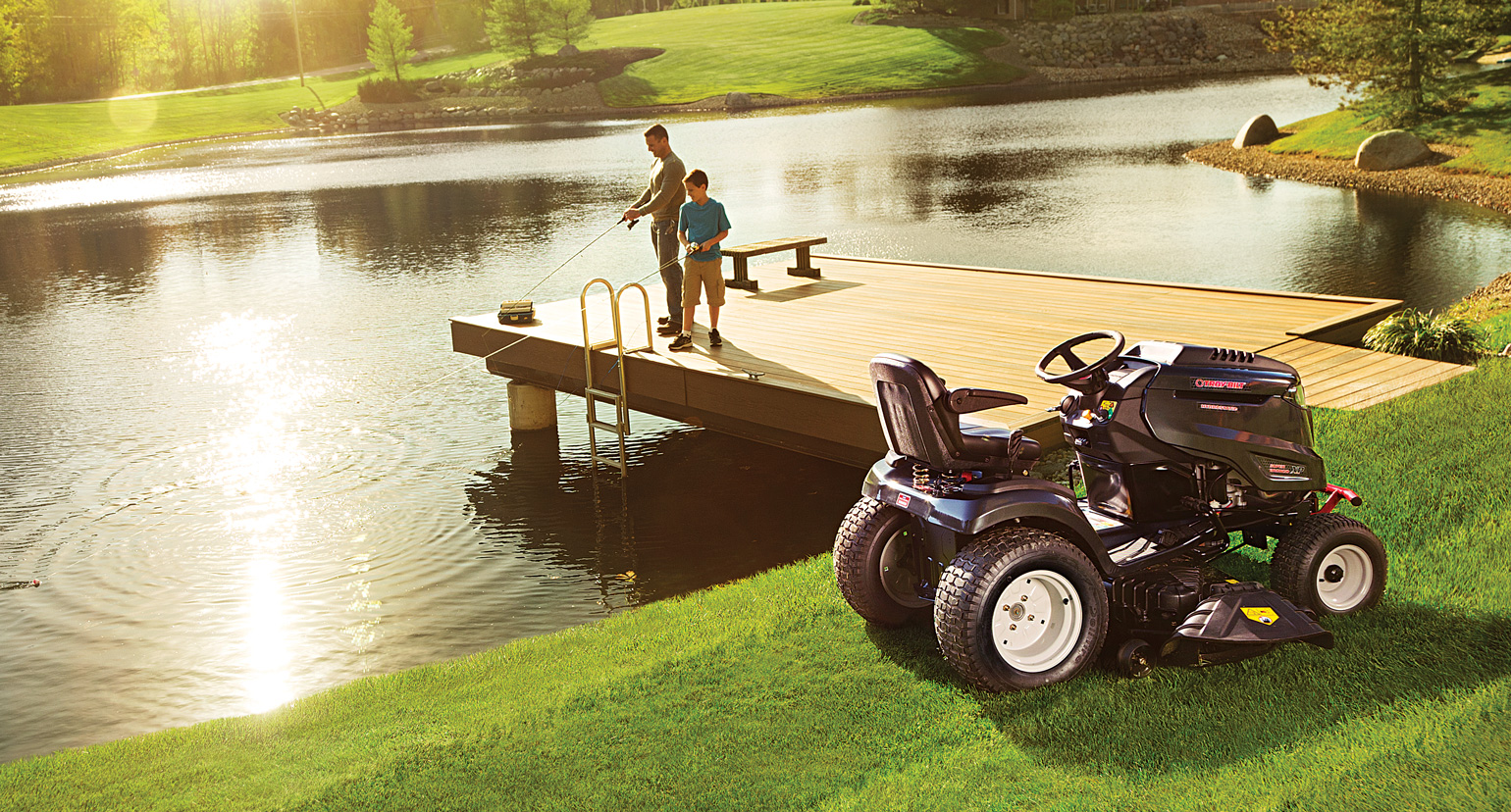 man on pier and riding lawn mower